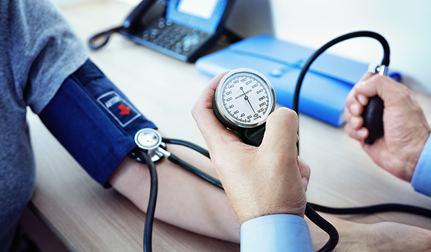 Doctor measuring blood pressure of patient